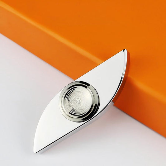 Silver leaf-shaped object on an orange and white background