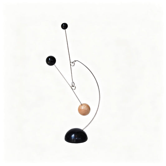 Kinetic balance mobile sculpture in wood and metal with three spheres