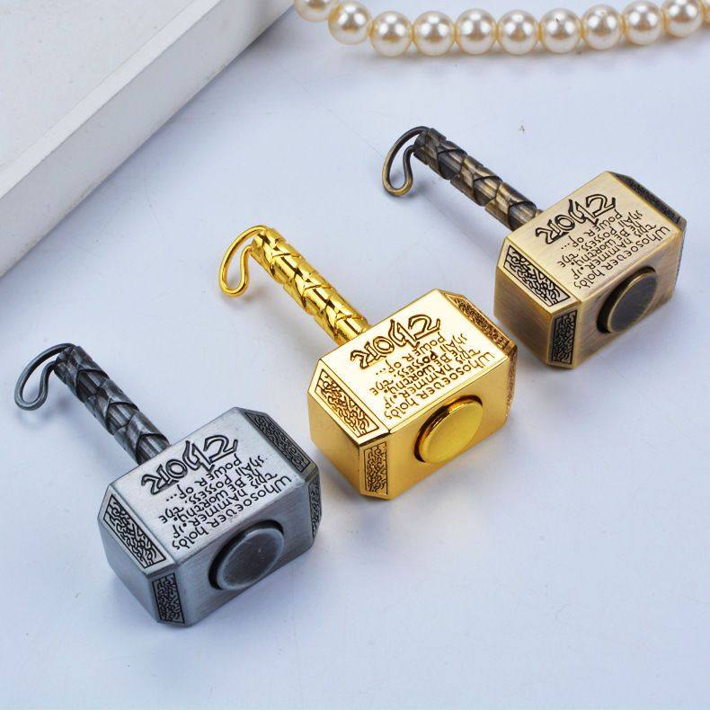 Brass Spinning Top | Premium Metal Fidget Toy | Stress Relief Desktop Gift displayed on a table with pearls.