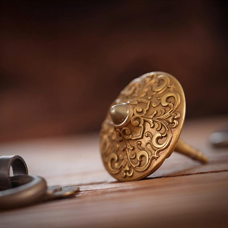 Brass Spinning Top | Premium Metal Fidget Toy | Stress Relief Desktop Gift on a wooden surface with intricate design.