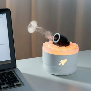 Cannon Turret Desk Humidifier - White version misting beside an open laptop