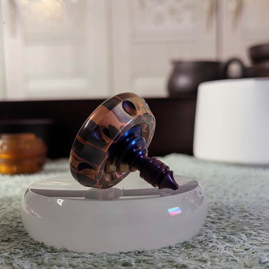 Titanium Niobium Fidget Spinner | Premium Metal Stress Relief Toy | Desktop Gift on a sleek surface in a cozy environment.