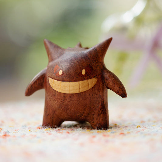 Wooden creature figurine with a smiling face on a natural background