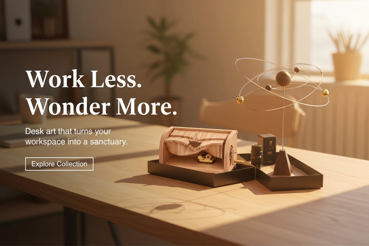 Decorative desk setup with text 'Work Less. Wonder More.' on a blurred office background.