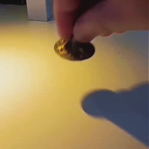 Brass Spinning Top | Premium Metal Fidget Toy | Stress Relief Desktop Gift being spun on a table.
